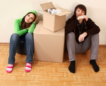 Student removals team handling boxes in a Hammersmith flat
