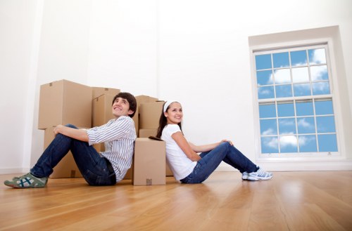 Trained movers handling boxes carefully during a Hammersmith move