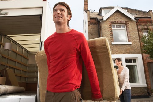 Careful loading of sofas, beds, and office furniture during collection