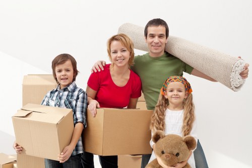 Mover carrying a box carefully through a property with caution