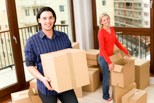 Packed moving boxes and furniture prepared for a home removal service in Hammersmith
